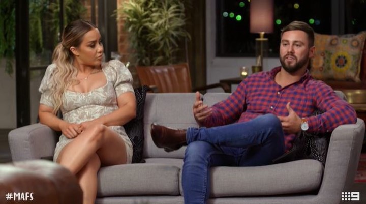 cathy and josh, sitting on a couch during a commitment ceremony mafsau season 7